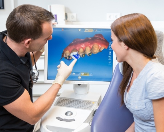 Two dentists reviewing bite impressions during training