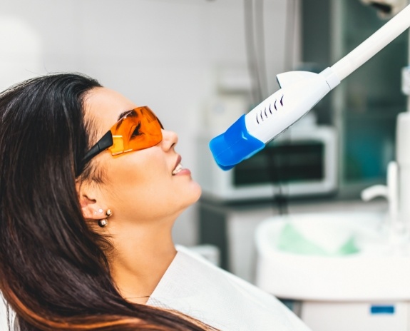 Dental patient receiving opalescence teeth whitening