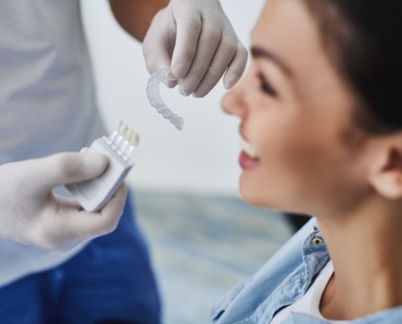 Woman's smile fitted for Invisalign clear braces during dental visit